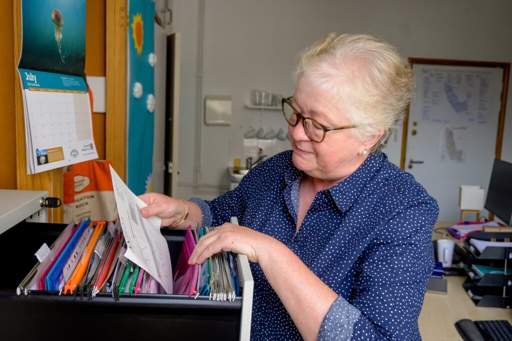 A woman organising files